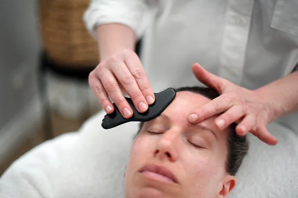 Using a Gua Sha tool that is made from Nephrite