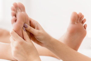 Reflexology being perfomed on a women's feet