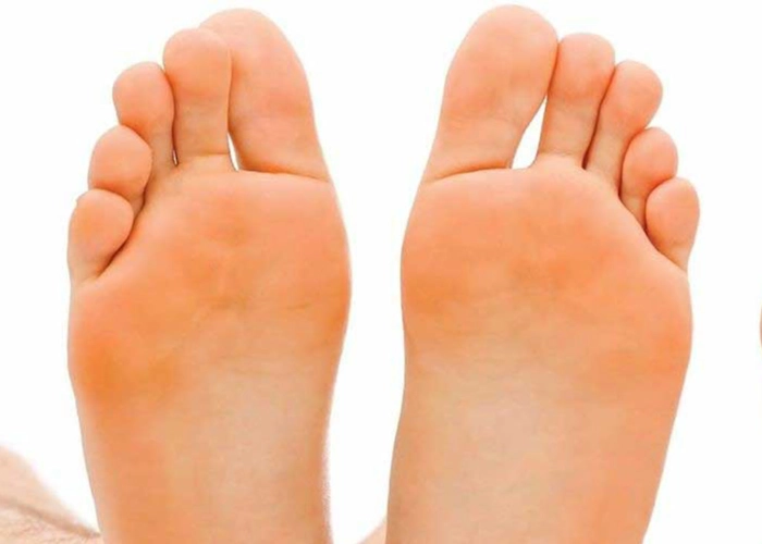 The soles of a womans feet pointing upwards
